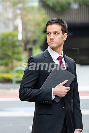 ビジネス街でスーツの男性が左を見る a0010356PH