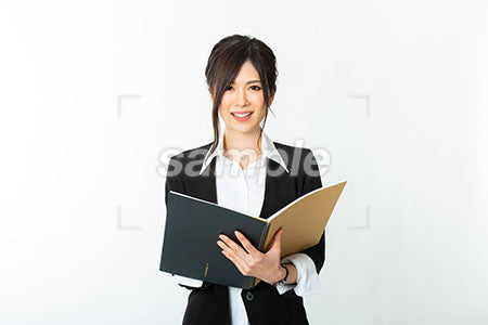 女性の笑顔の表情で筆記用具を持っている a0020699PH