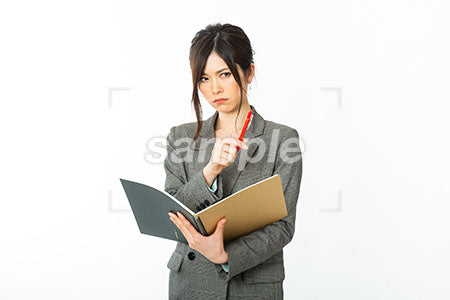 ノートを持って立腹する女性OL a0021140PH