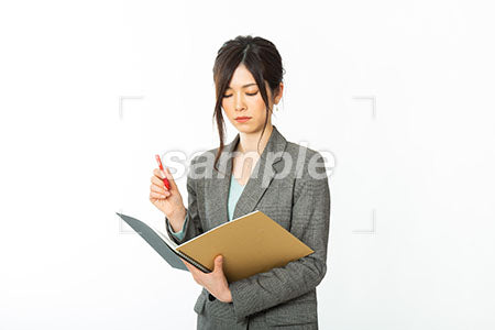 ノートを書きながら目を閉じる女性社員 a0021160PH