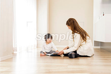 絵本を赤ちゃんに読み聞かせる若いお母さん a0030543PH