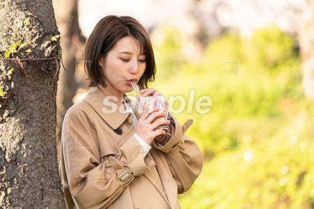 公園で飲みのものを飲む女性OL 下を見る a0050659PH